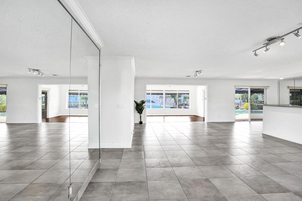 2632 Southeast 10th Court Pompano Beach, FL 33062 - Photo 5 of 49 a view of an entryway with wooden floor and a kitchen