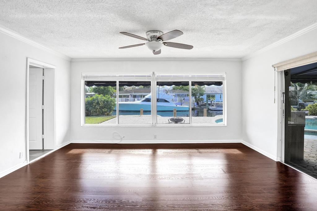 2632 Southeast 10th Court Pompano Beach, FL 33062 - Photo 9 of 49 a view of empty room with wooden floor and fan