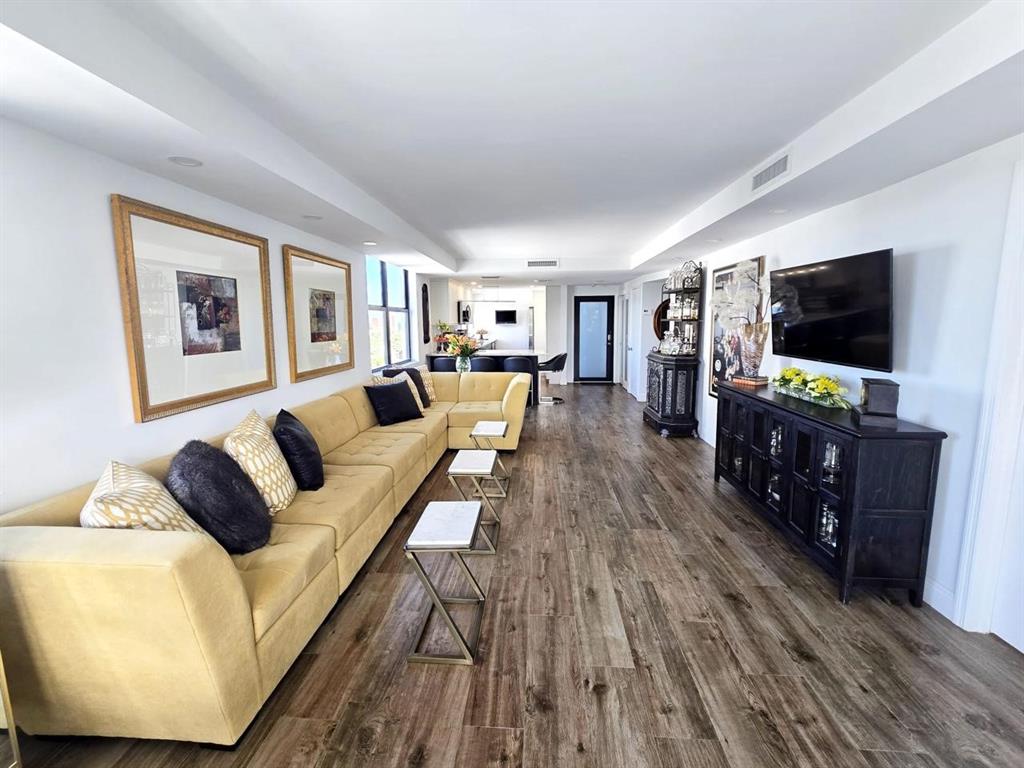 1401 North Riverside Drive, Unit 707 Pompano Beach, FL 33062 - Photo 2 of 32 a living room with furniture and a flat screen tv