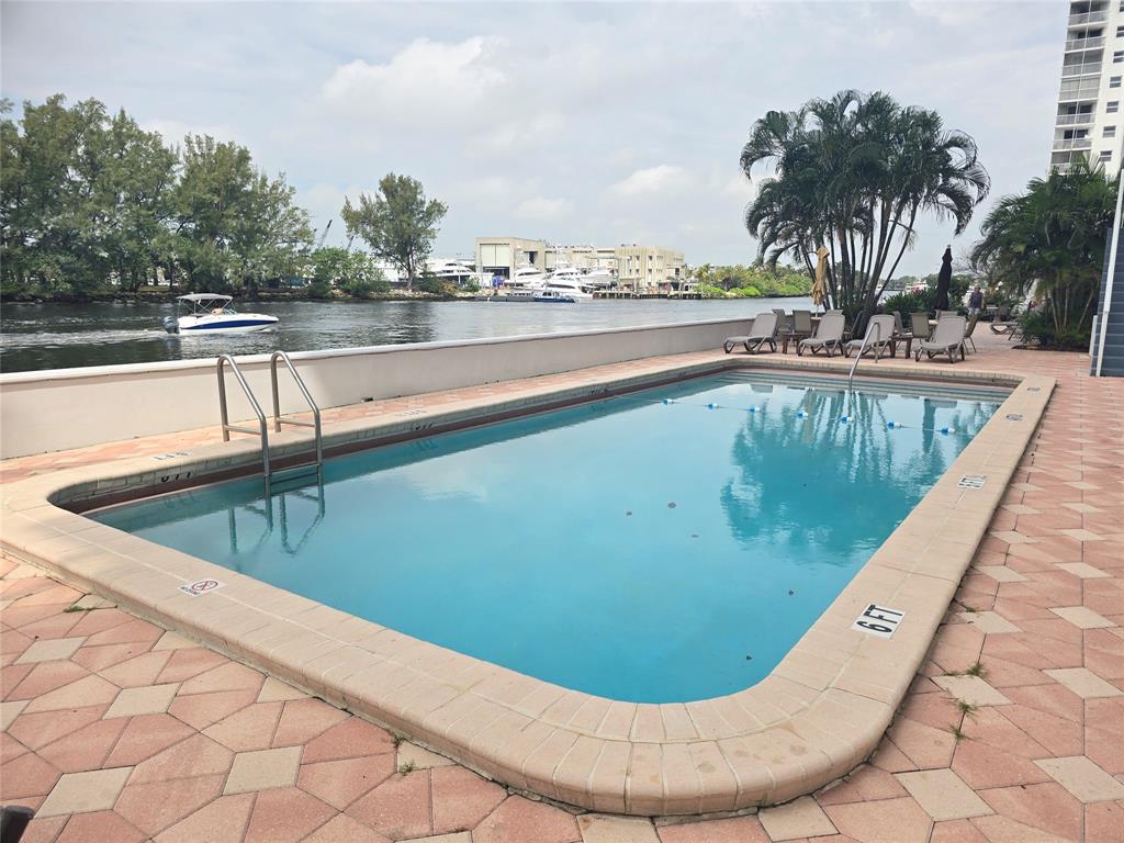 1401 North Riverside Drive, Unit 707 Pompano Beach, FL 33062 - Photo 21 of 32 a view of swimming pool with a garden and seating