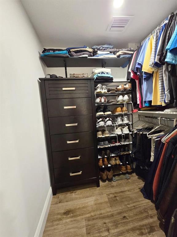 1401 North Riverside Drive, Unit 707 Pompano Beach, FL 33062 - Photo 9 of 32 a view of walk in closet with clothes and shoes