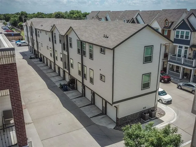 an aerial view of a house with wooden fence