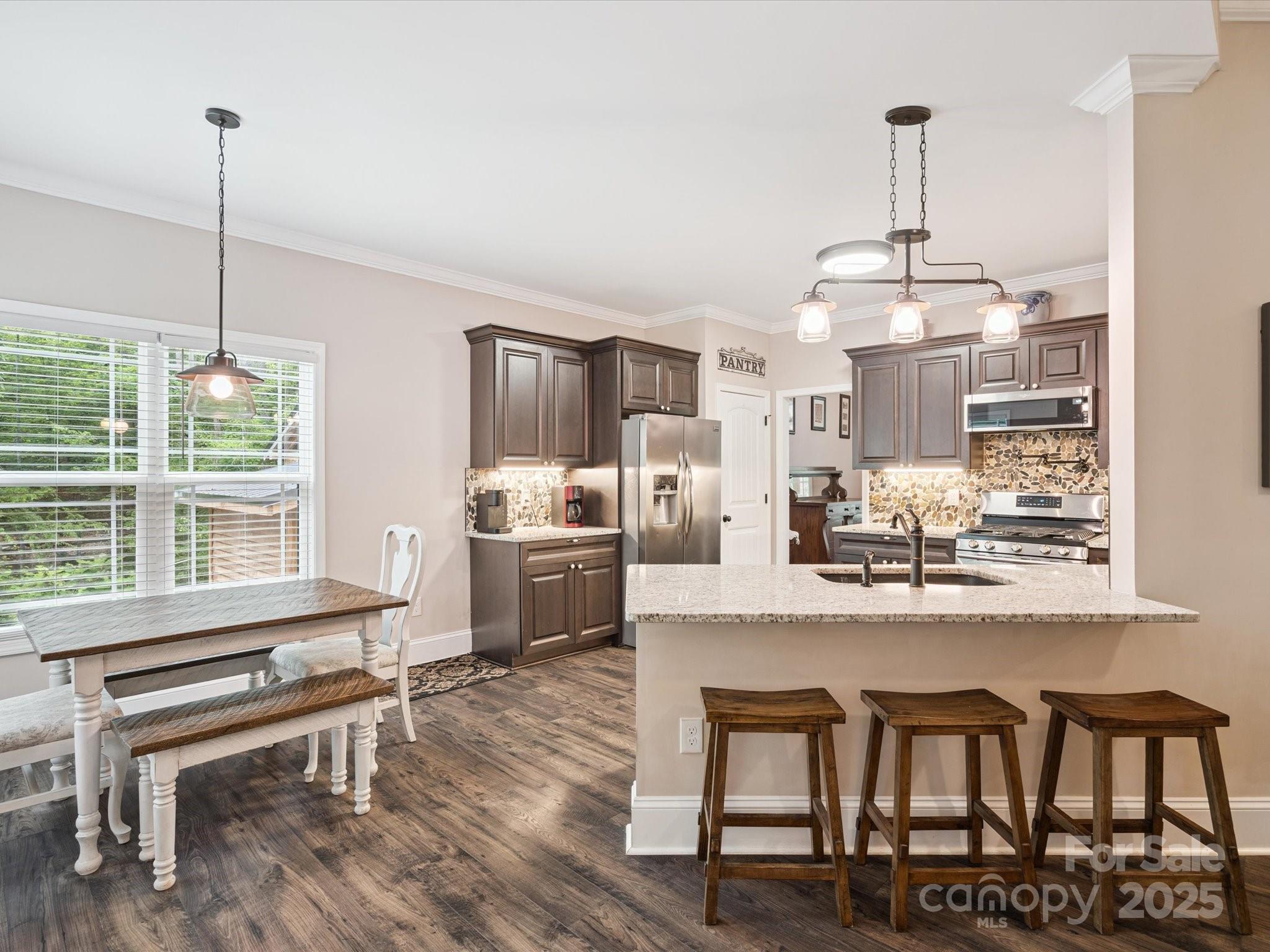820 King Road Clover, SC 29710 - Photo 11 of 48 a kitchen with granite countertop a stove a table and chairs