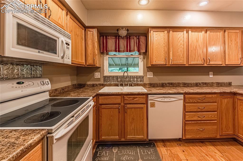 1917 Wooten Road Colorado Springs, CO 80915 - Photo 11 of 35 a kitchen that has a sink and a stove in it