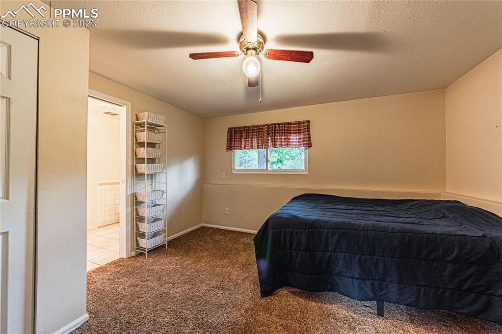 1917 Wooten Road Colorado Springs, CO 80915 - Photo 15 of 35 a bedroom with a bed and a cabinet
