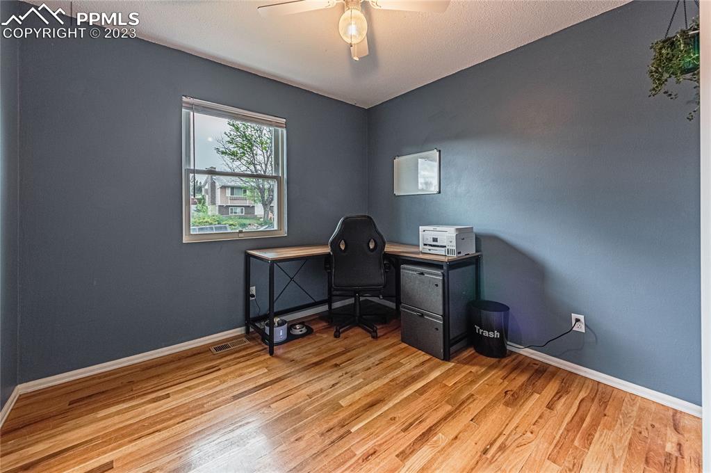1917 Wooten Road Colorado Springs, CO 80915 - Photo 19 of 35 a view of a workspace with furniture and a window