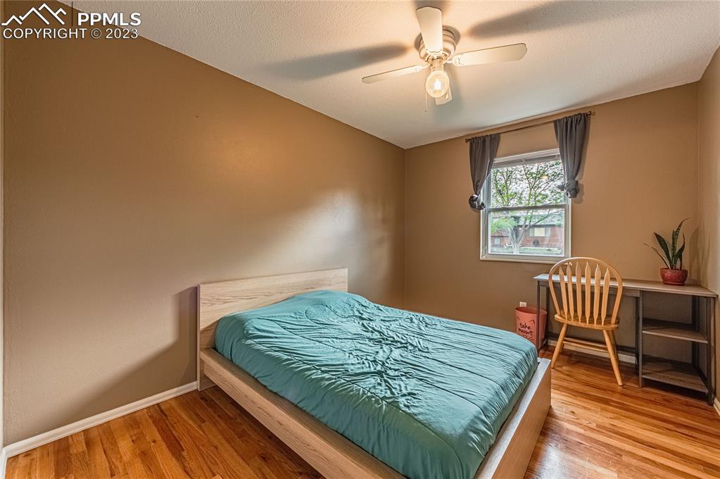 1917 Wooten Road Colorado Springs, CO 80915 - Photo 21 of 35 a bed sitting in a bedroom next to a window