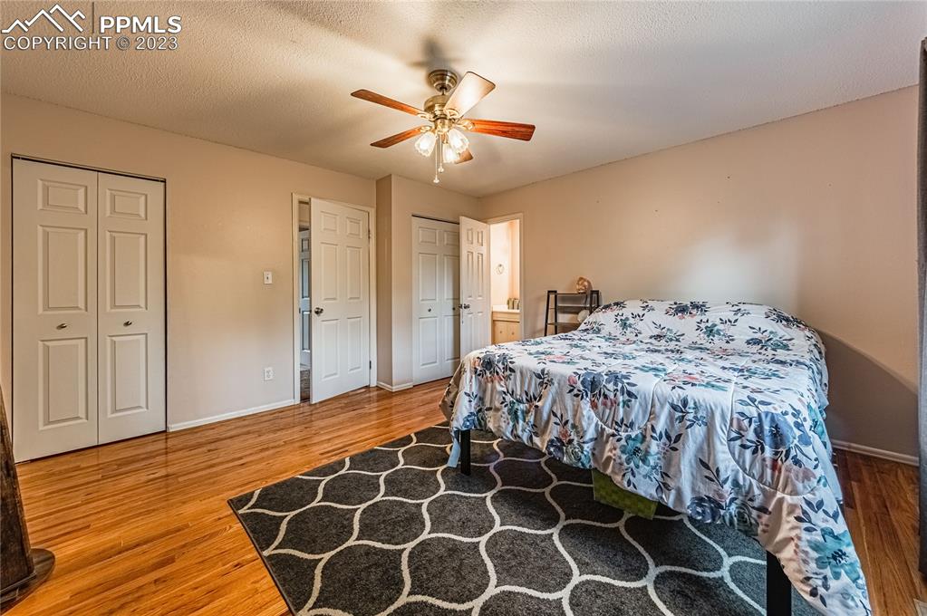 1917 Wooten Road Colorado Springs, CO 80915 - Photo 24 of 35 a bedroom with a bed and a mirror
