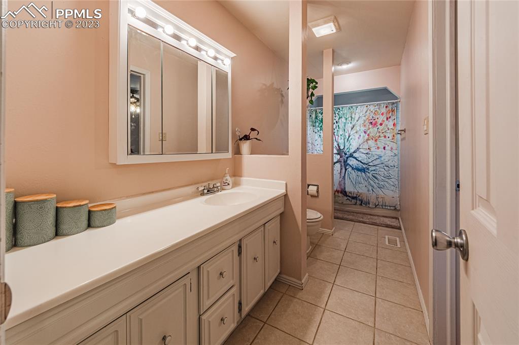 1917 Wooten Road Colorado Springs, CO 80915 - Photo 26 of 35 a spacious bathroom with a shower and a sink