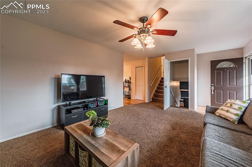 1917 Wooten Road Colorado Springs, CO 80915 - Photo 5 of 35 a living room with furniture and a flat screen tv