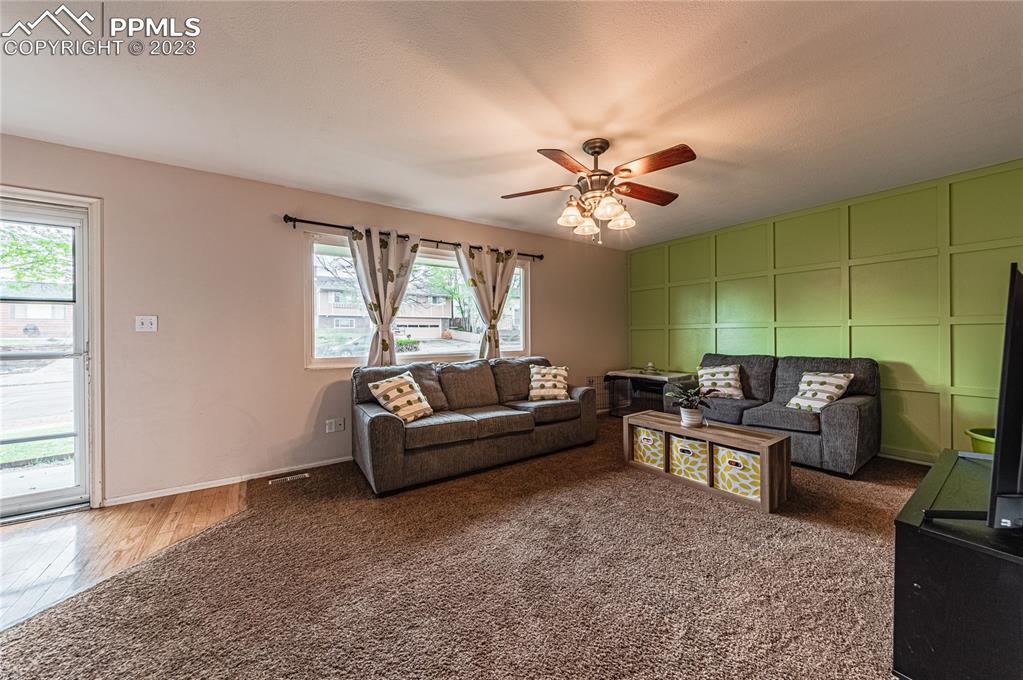 1917 Wooten Road Colorado Springs, CO 80915 - Photo 6 of 35 a living room with furniture and a large window