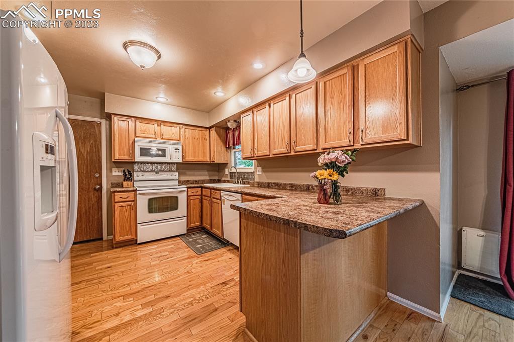 1917 Wooten Road Colorado Springs, CO 80915 - Photo 9 of 35 a kitchen with stainless steel appliances granite countertop a stove sink and refrigerator