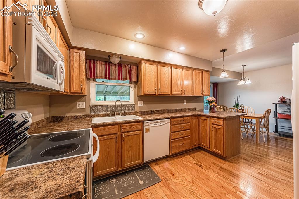 1917 Wooten Road Colorado Springs, CO 80915 - Photo 10 of 35 a kitchen with a sink window and cabinets