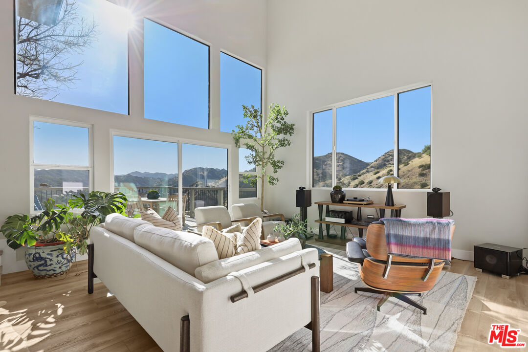53 Saddlebow Road Bell Canyon, CA 91307 - Photo 8 of 66 a living room with furniture plant and a large window