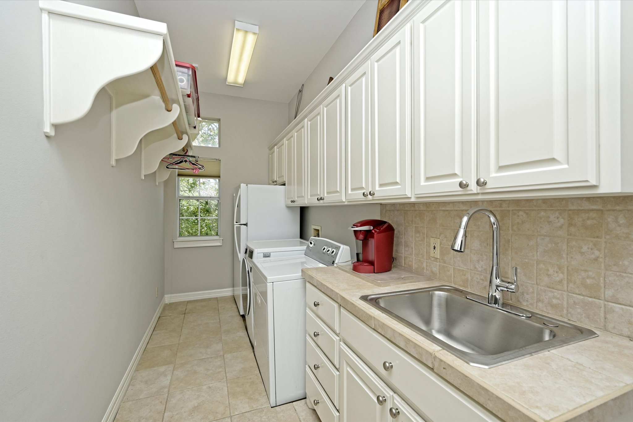 4912 Interlachen Lane Austin, TX 78747 - Photo 12 of 39 a kitchen with a sink cabinets and a window