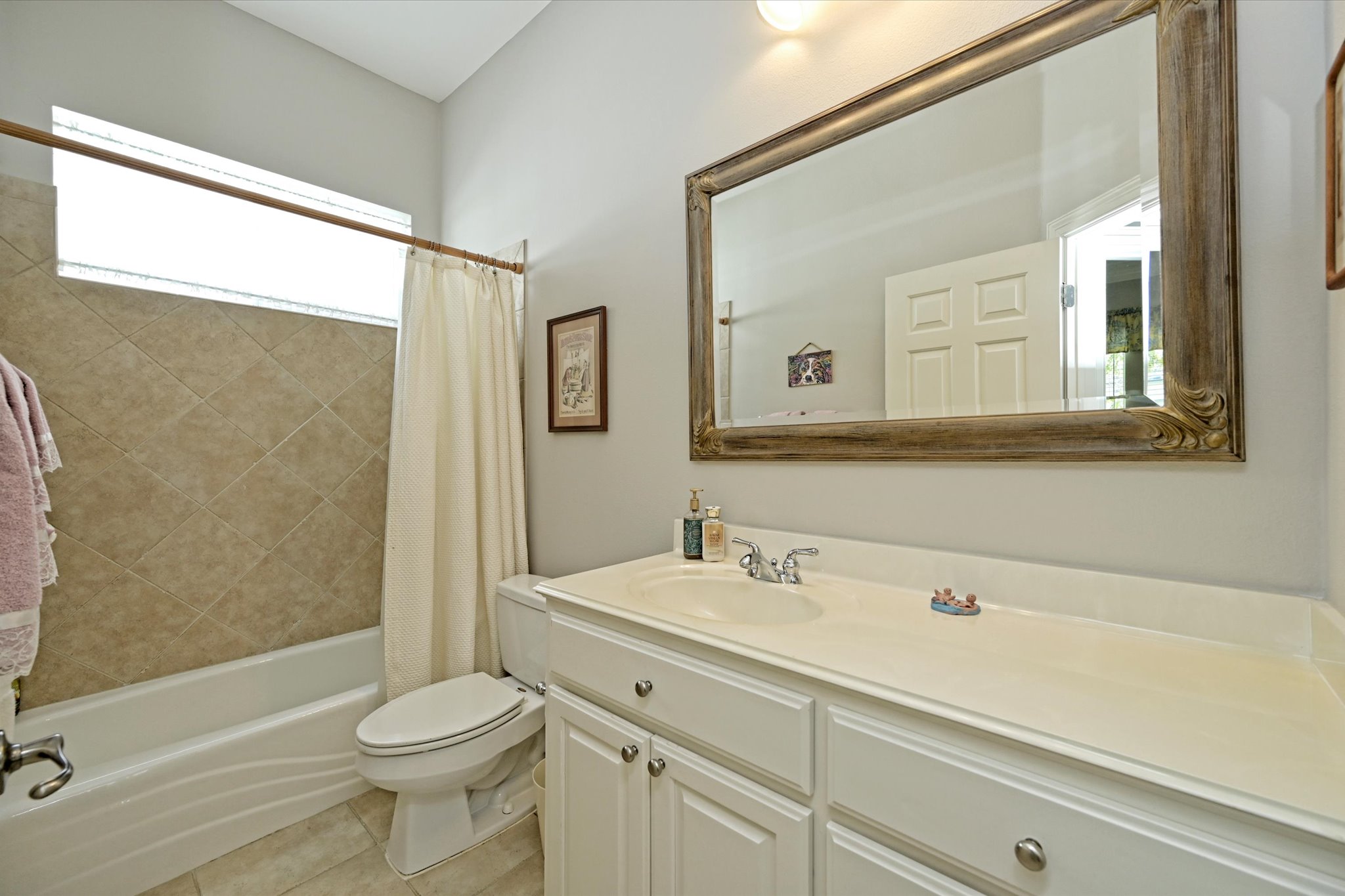4912 Interlachen Lane Austin, TX 78747 - Photo 19 of 39 a bathroom with a sink a toilet and a bathtub