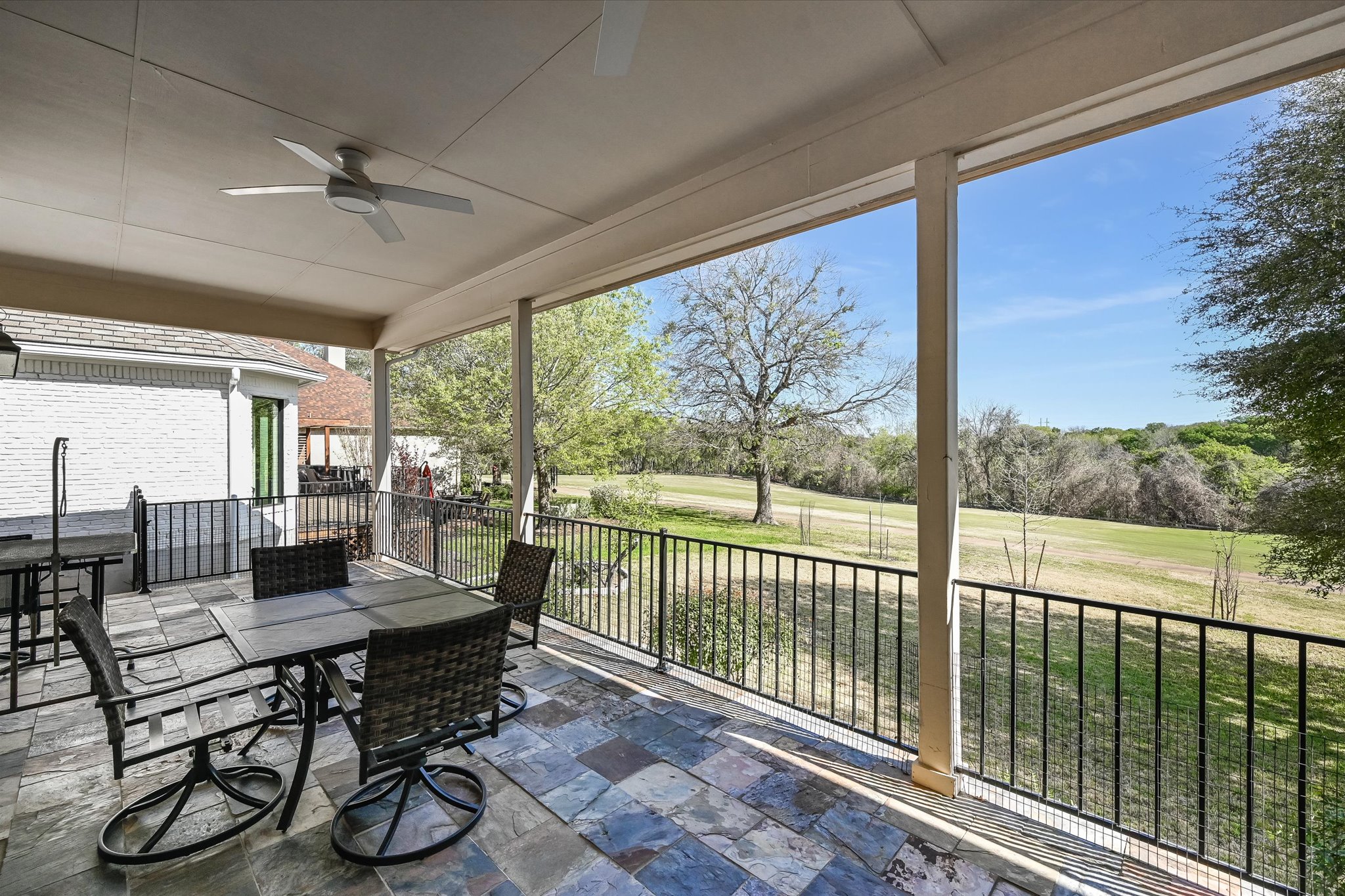 4912 Interlachen Lane Austin, TX 78747 - Photo 24 of 39 a dining room with furniture water view and a floor to ceiling window