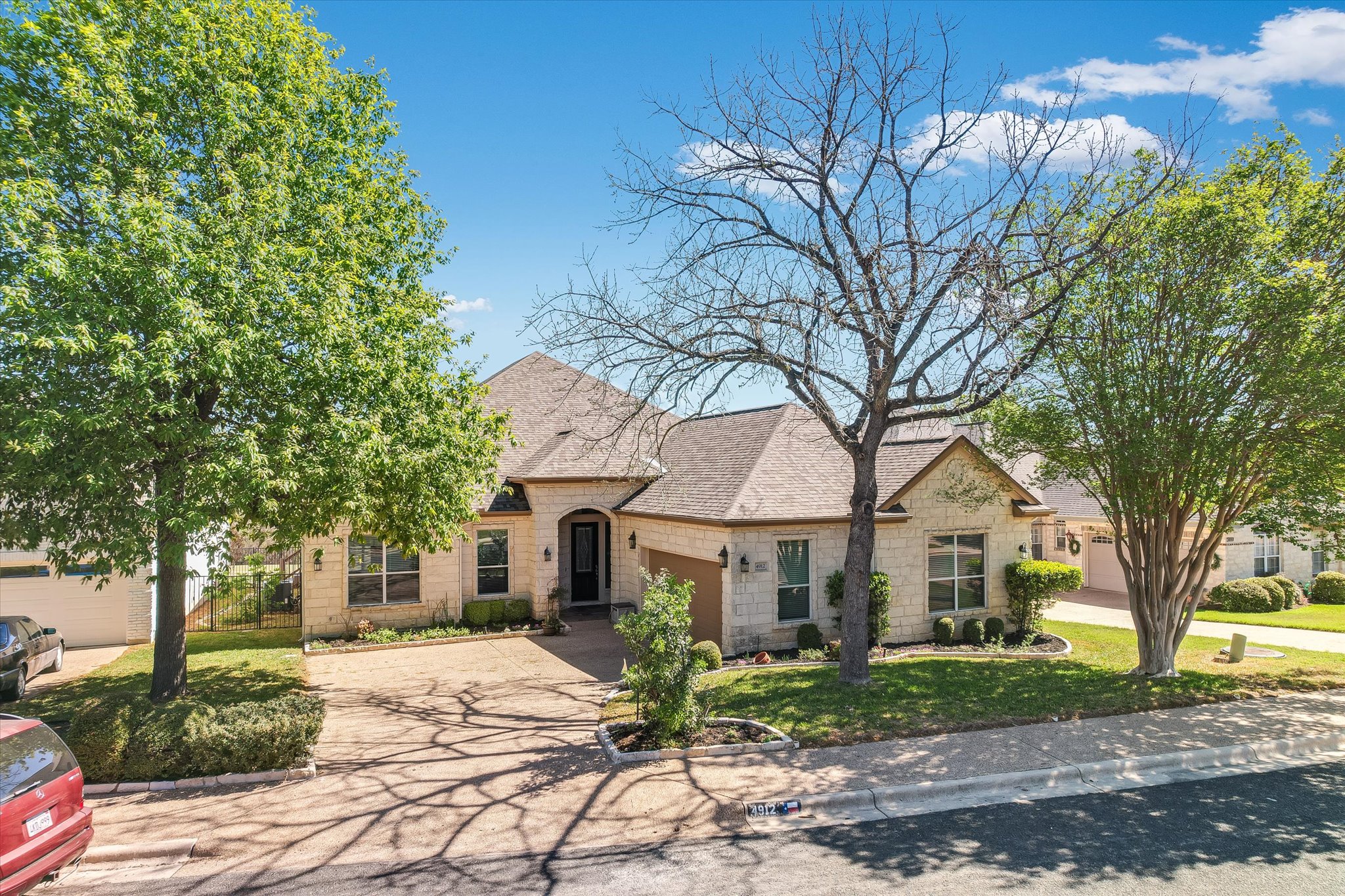 4912 Interlachen Lane Austin, TX 78747 - Photo 37 of 39 a front view of a house with garden and trees