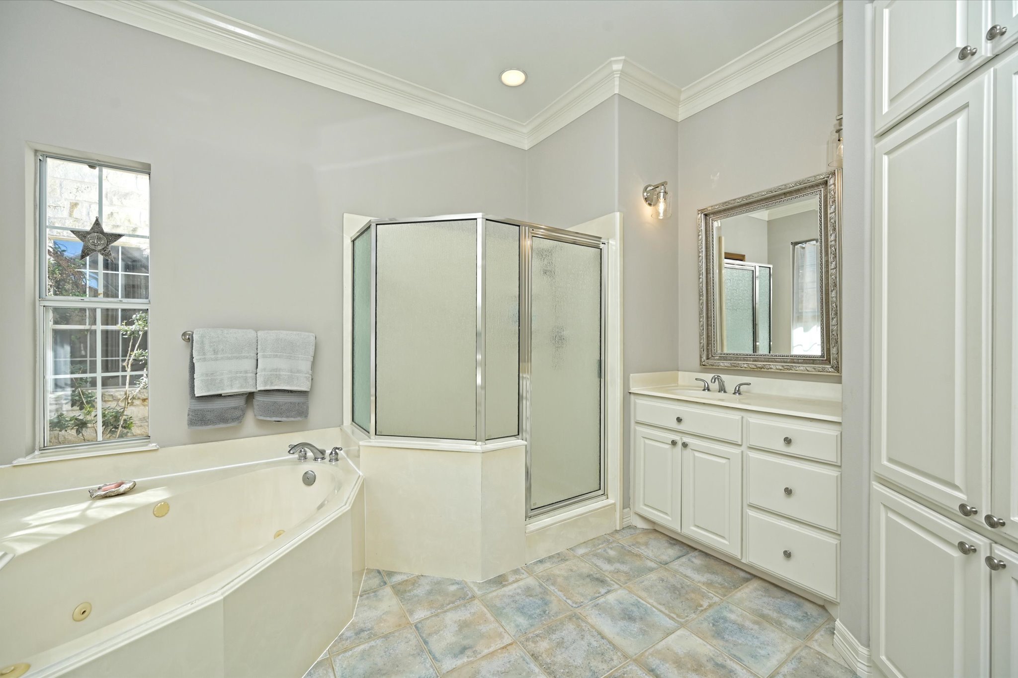 4912 Interlachen Lane Austin, TX 78747 - Photo 39 of 39 a spacious bathroom with a tub sink shower and mirror