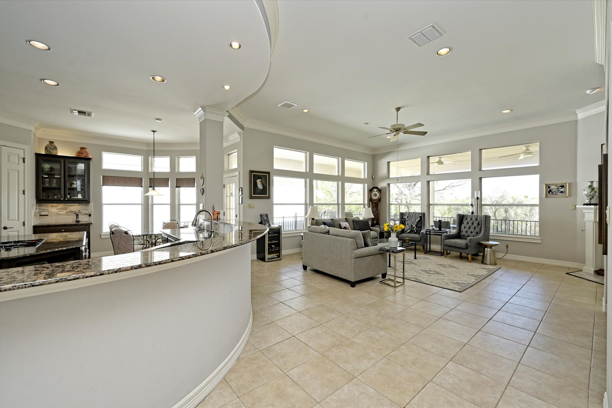 4912 Interlachen Lane Austin, TX 78747 - Photo 6 of 39 a large living room with stainless steel appliances kitchen island granite countertop a large window and couch
