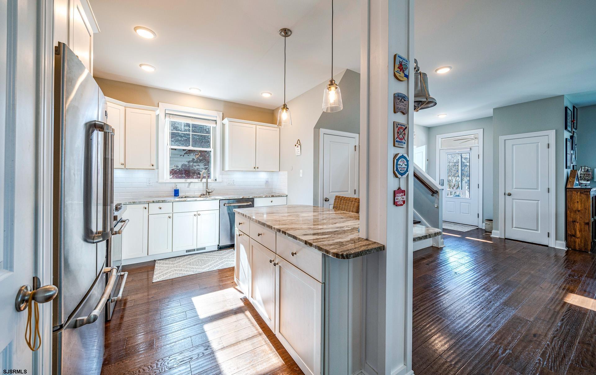 225 West Inlet Road Ocean City, NJ 08226 - Photo 11 of 56 a kitchen with stainless steel appliances granite countertop a refrigerator a sink dishwasher and a stove with wooden floor