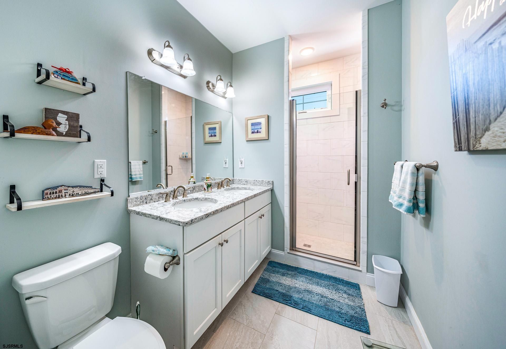 225 West Inlet Road Ocean City, NJ 08226 - Photo 14 of 56 a bathroom with a toilet sink and mirror