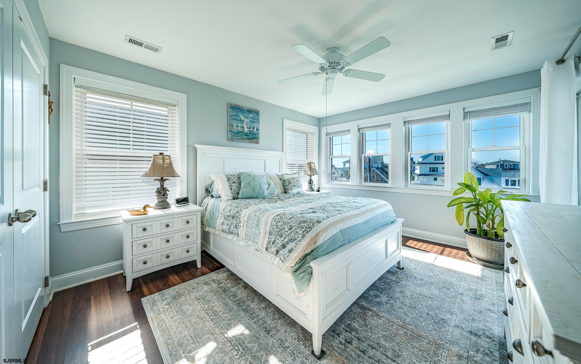 225 West Inlet Road Ocean City, NJ 08226 - Photo 17 of 56 a spacious bedroom with a bed a chandelier and dresser