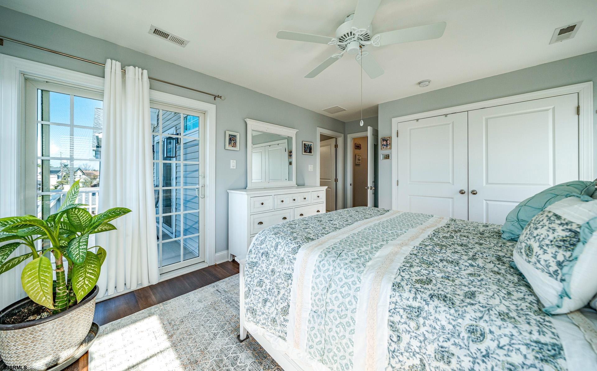 225 West Inlet Road Ocean City, NJ 08226 - Photo 18 of 56 a spacious bedroom with a bed and a potted plant