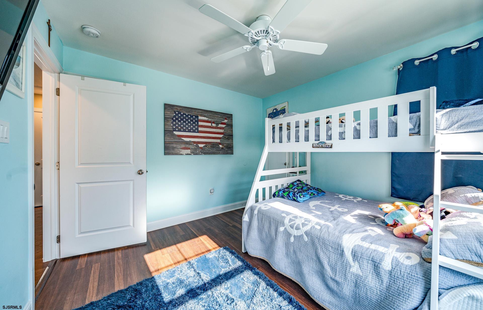 225 West Inlet Road Ocean City, NJ 08226 - Photo 22 of 56 a bed sitting in a bedroom next to a window