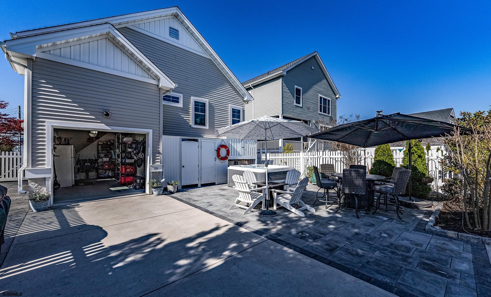 225 West Inlet Road Ocean City, NJ 08226 - Photo 31 of 56 a view of the patio with table and chairs under an umbrella