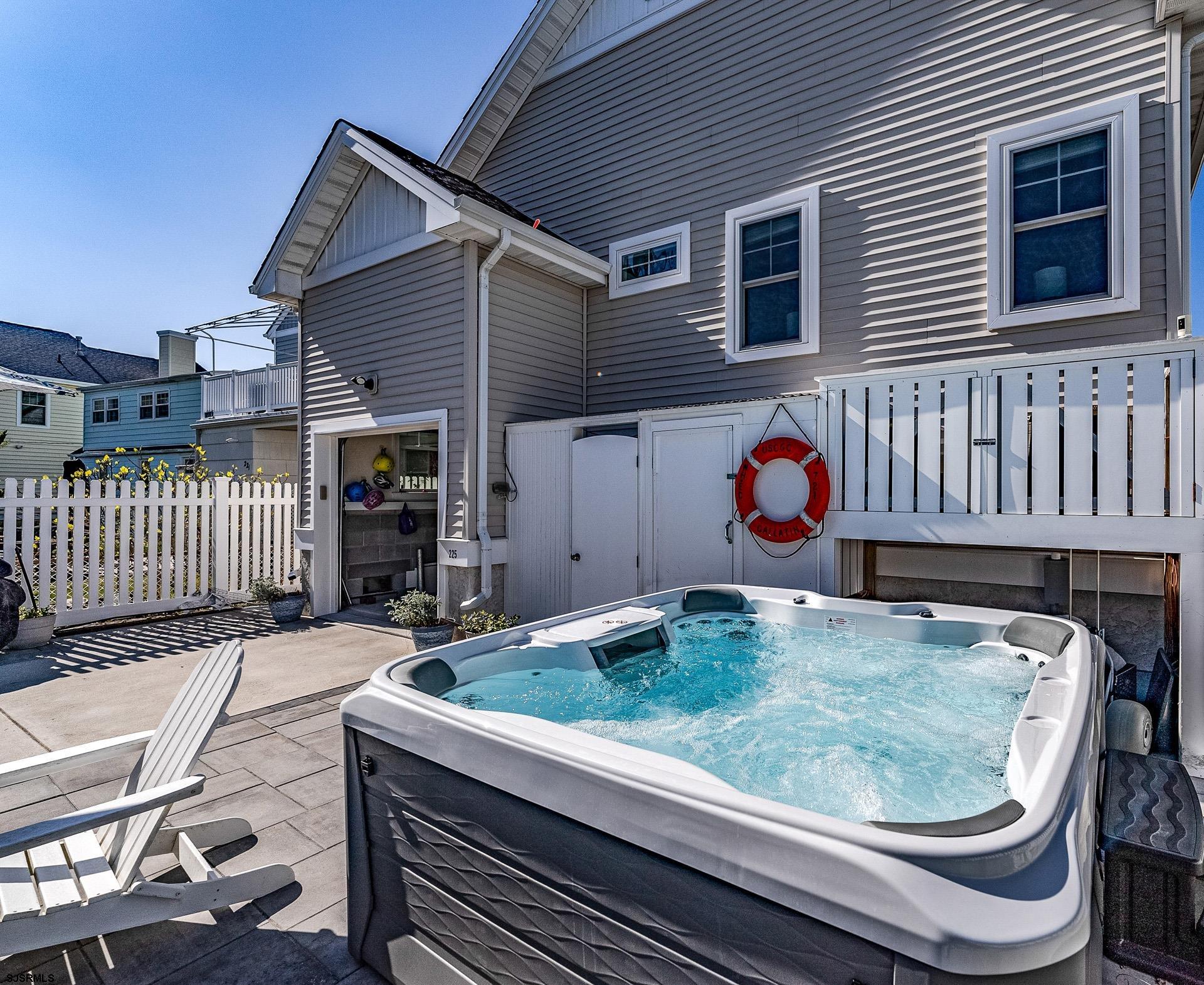 225 West Inlet Road Ocean City, NJ 08226 - Photo 34 of 56 a backyard of a house with barbeque oven and seating space