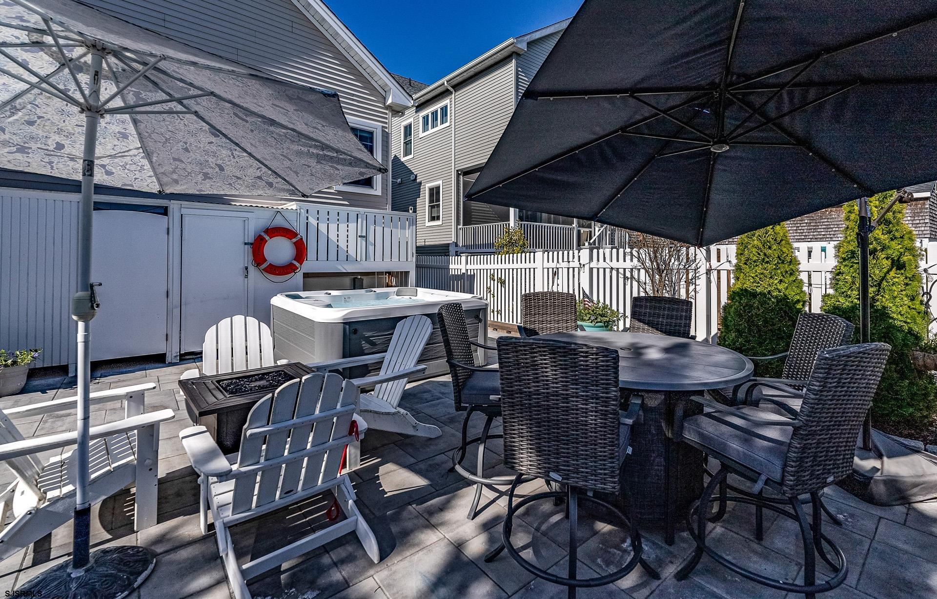 225 West Inlet Road Ocean City, NJ 08226 - Photo 36 of 56 a view of a patio with table and chairs under an umbrella