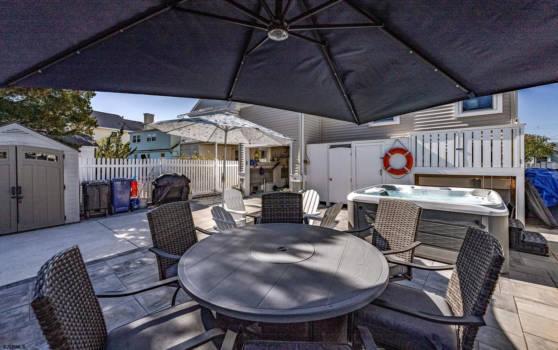 225 West Inlet Road Ocean City, NJ 08226 - Photo 37 of 56 a patio with a table and chairs