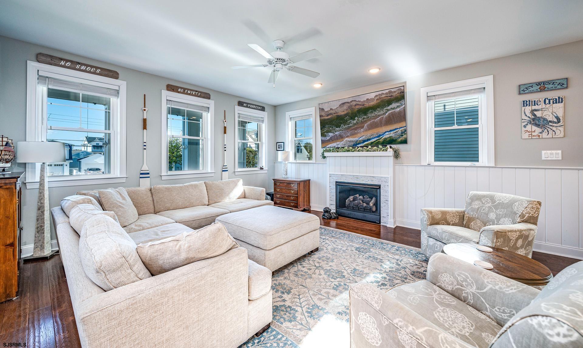 225 West Inlet Road Ocean City, NJ 08226 - Photo 6 of 56 a living room with furniture fireplace and a large window