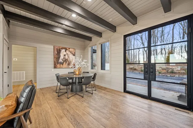 a view of a dining room with furniture window and wooden floor