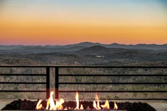 a view of a yard with wooden fence