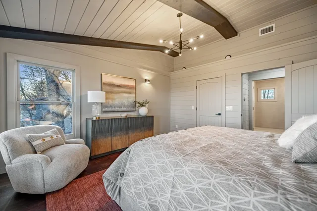 a bedroom with a bed and ceiling fan