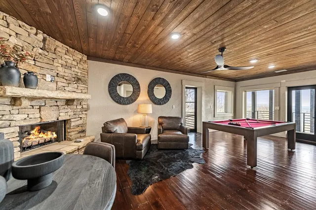 a living room with fireplace furniture and a large window