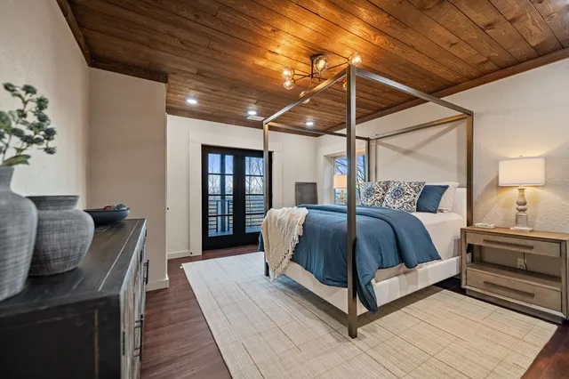 a bed sitting in a bedroom next to a lamp