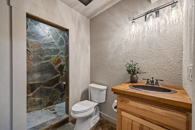 a bathroom with a sink toilet and shower