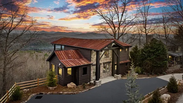 a view of a house with a small yard and a wooden deck