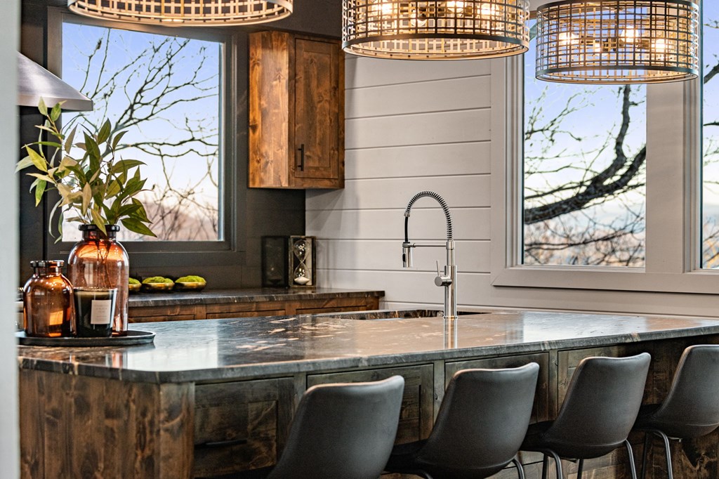 799 Bruce Mountain Road Morganton, GA 30560 - Photo 7 of 48 a kitchen with a table chairs and a potted plant