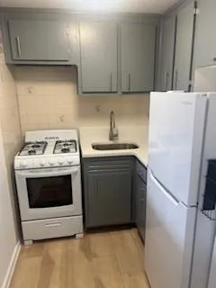 a kitchen with a stove a refrigerator and a sink