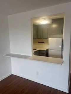 a view of kitchen with a refrigerator