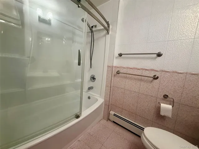 a bathroom with a granite countertop toilet a sink and shower