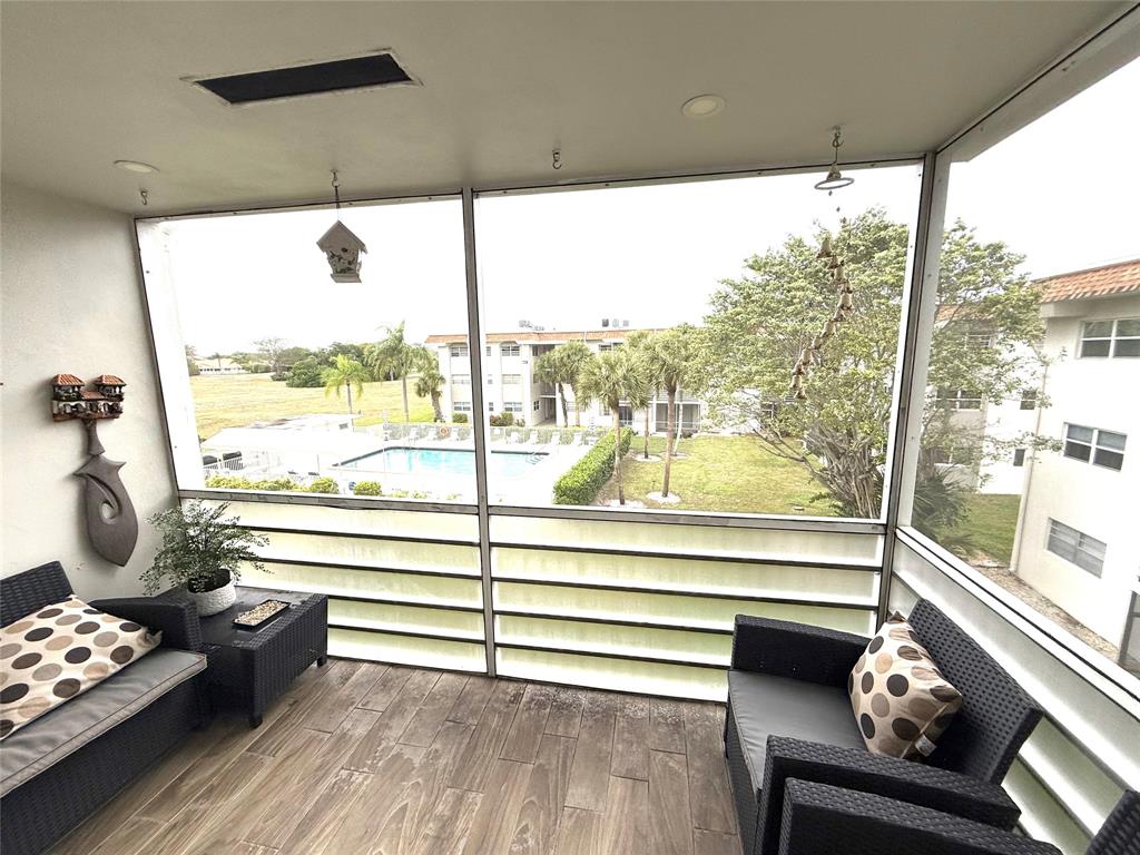 5601 Northwest 2nd Avenue, Unit 3190 Boca Raton, FL 33487 - Photo 11 of 16 a living room with furniture and a floor to ceiling window