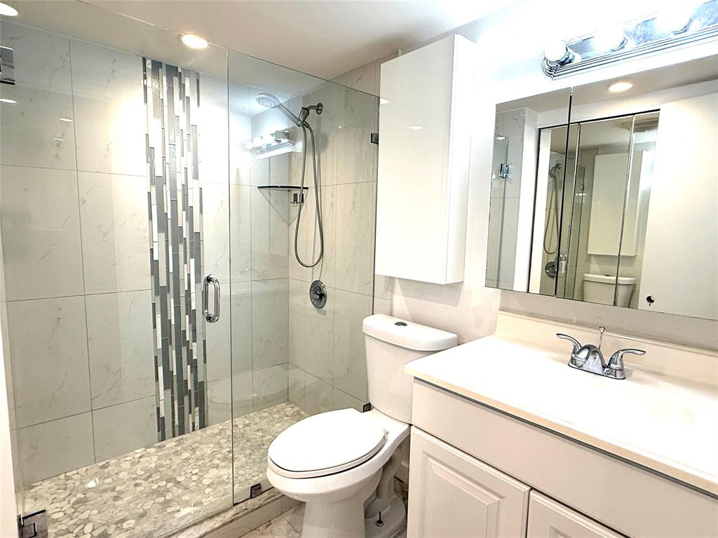 5601 Northwest 2nd Avenue, Unit 3190 Boca Raton, FL 33487 - Photo 5 of 16 a bathroom with a sink toilet and shower