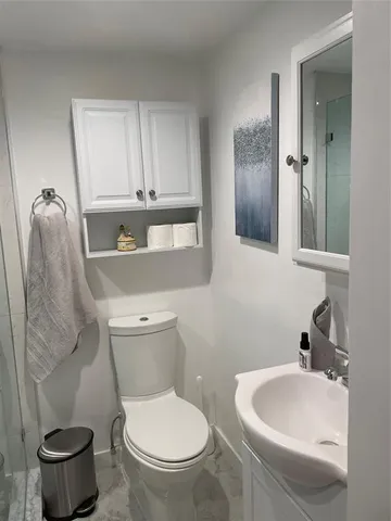 a bathroom with a sink and a glass door shower