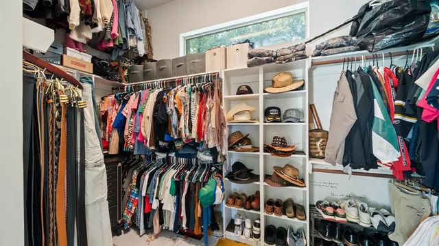 a spacious bedroom with two beds and a chandelier