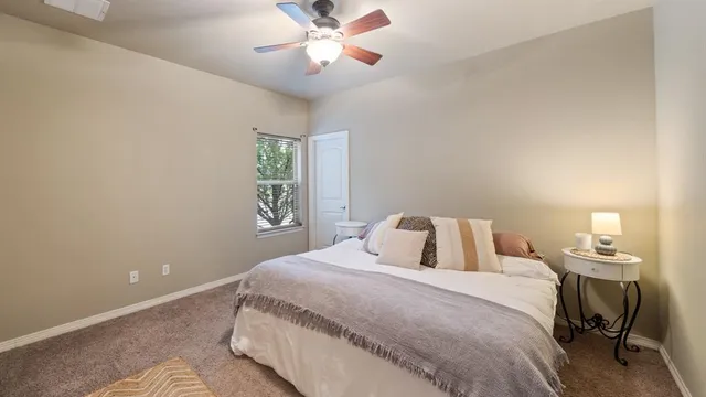 a view of a house with backyard and trees